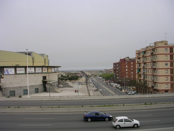 cars traveling down the road in the city