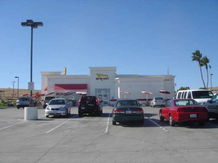 an empty lot next to a mcdonalds with several cars parked in it