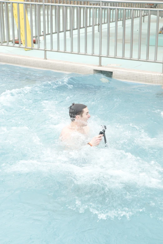 a man riding a water ski while holding onto a black device