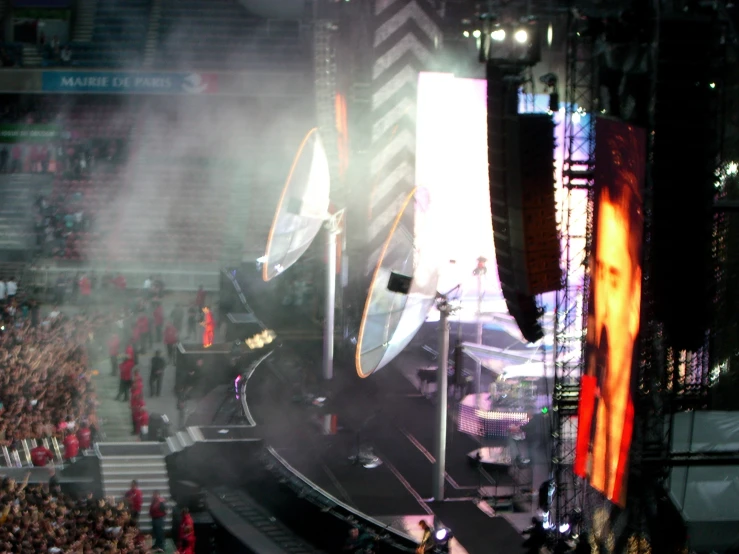 a crowd of people watching a performer on a stage