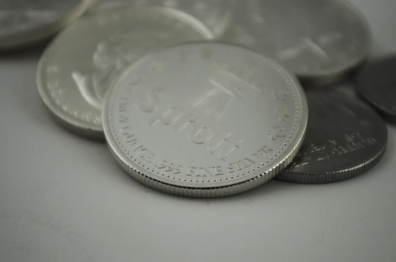 a pile of silver coin laying on top of each other