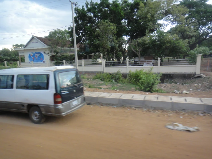 there is a white van parked on the side of the road