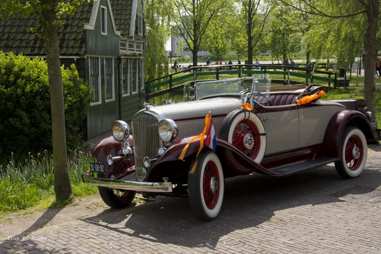 an old fashioned car is parked on the side of the road