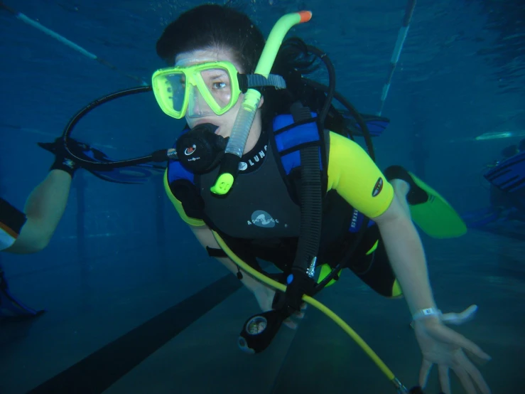 a woman wearing scuba gear diving in the water