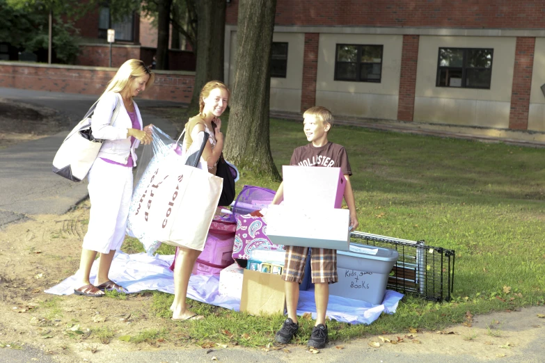 some children are standing next to some bags