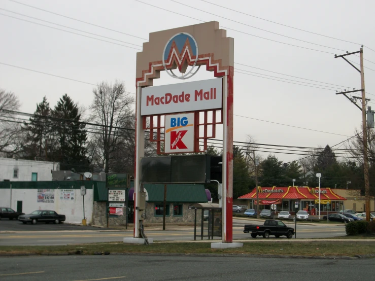 a large building with a large sign that reads mcccote mall