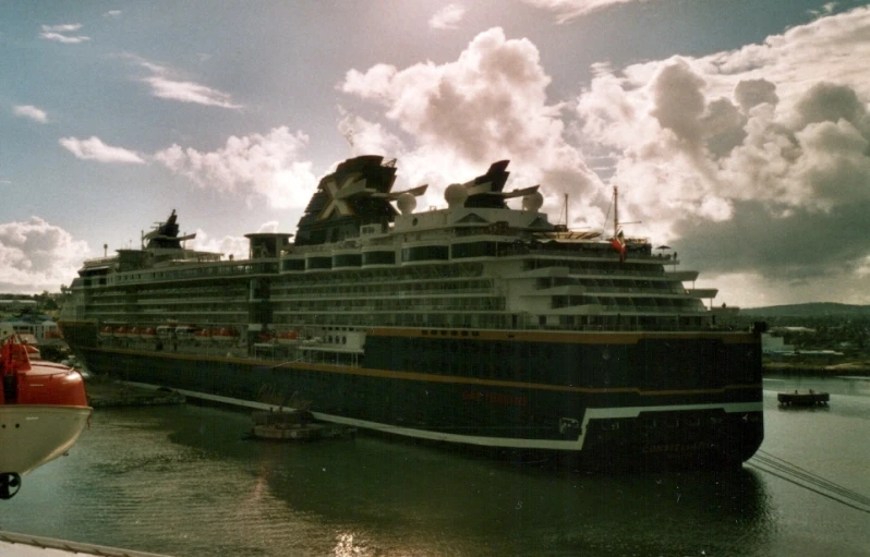 a large ship next to a smaller boat in the water