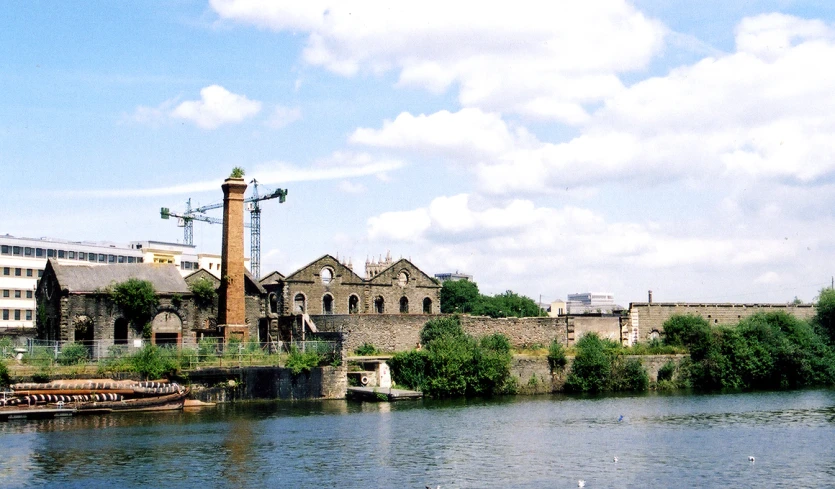 a large building sitting next to a river