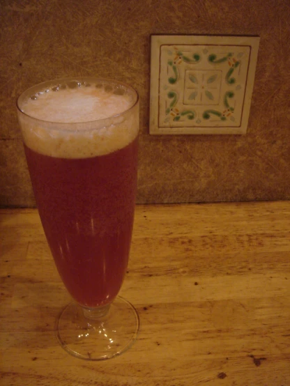 a tall glass with soing white inside