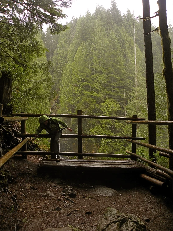 the man is using his hand to cross the bridge