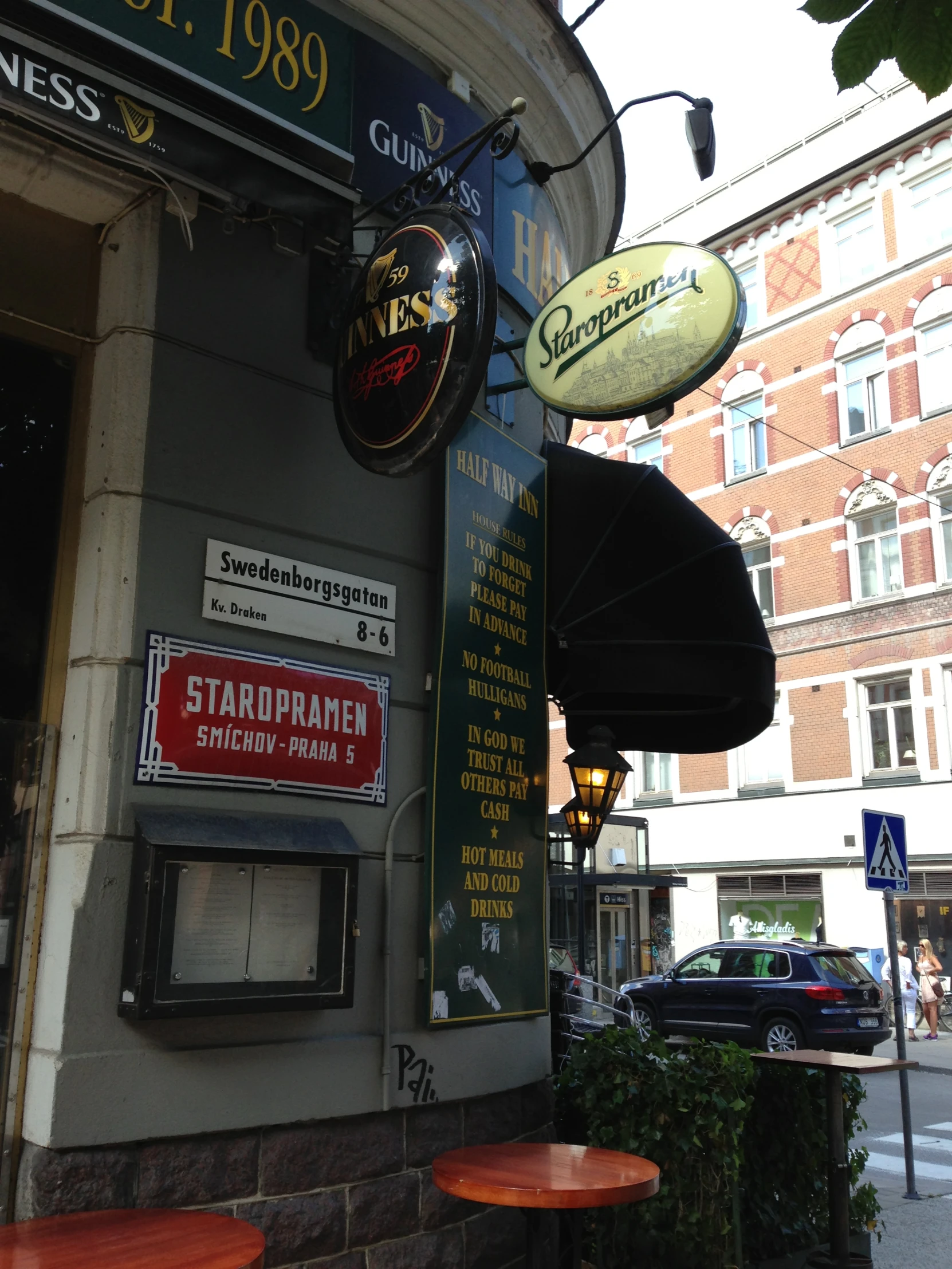 two tables and umbrellas line the outside of an eatery