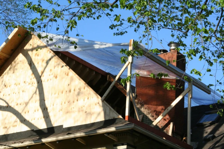 a house with no roof and some shingles on it