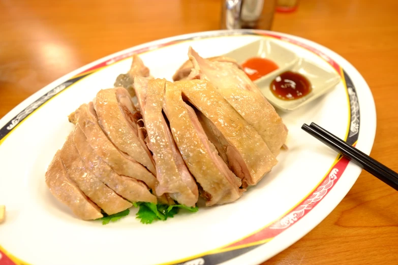 a dish of pork on a plate with some sauce