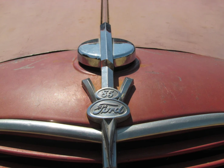 the emblem on the front end of a red car