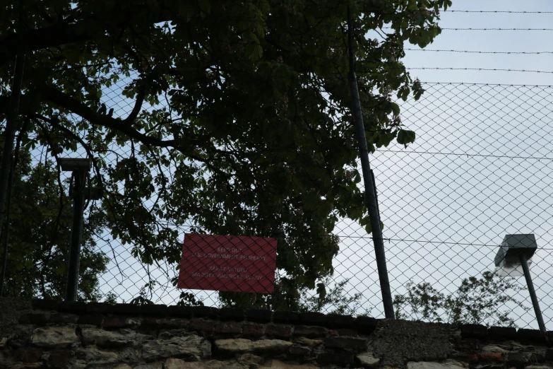 a basketball hoop behind a chain link fence