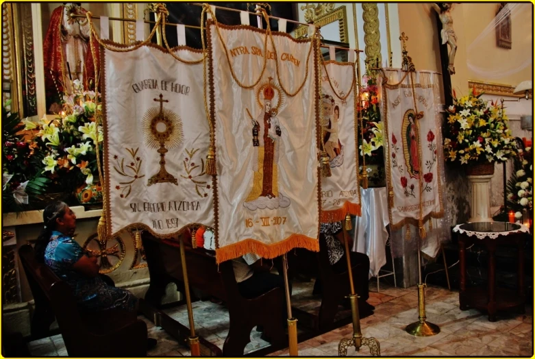 a person is sitting down and praying in front of a banner