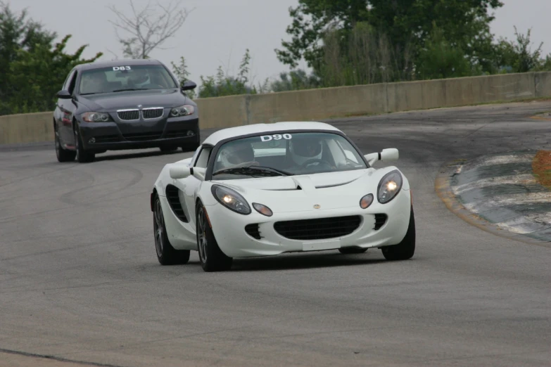 two cars driving in different directions on a track