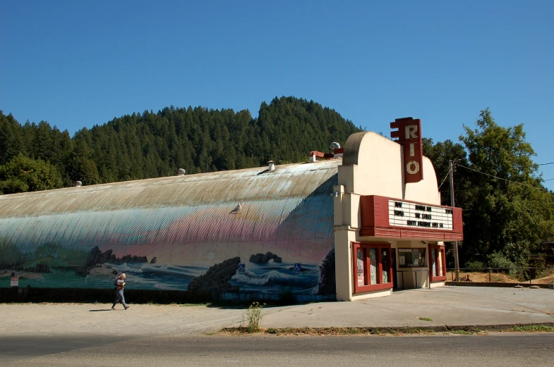 there is a painting on the building next to a road