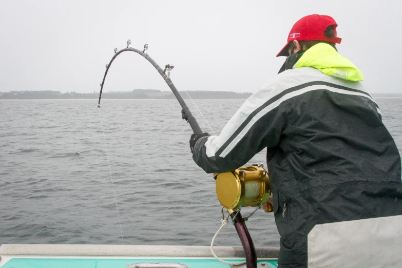 a man is fishing on a small boat in the water