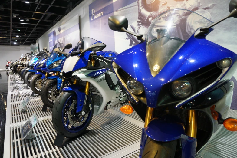 several motorcycles sit in a row on display