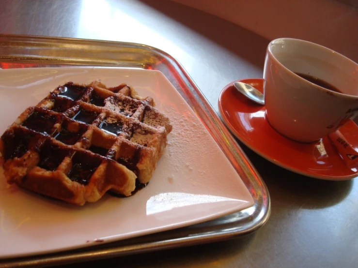 waffles served on two plates next to coffee
