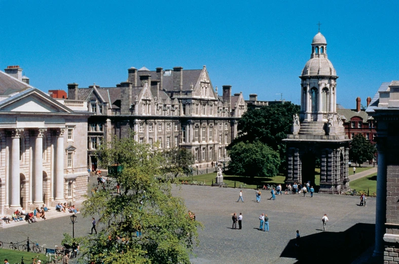 some people are walking in front of many buildings