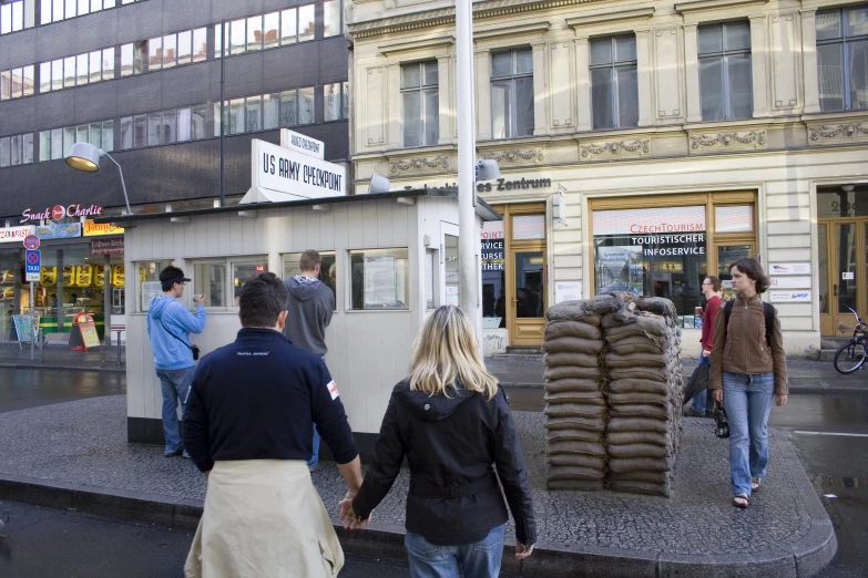 the two people walk on the sidewalk with bags on each side