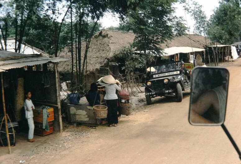 several people are loading up supplies from the back of trucks