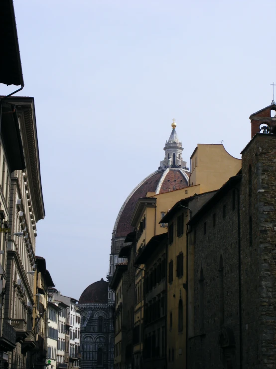 a small tower stands near an old city street