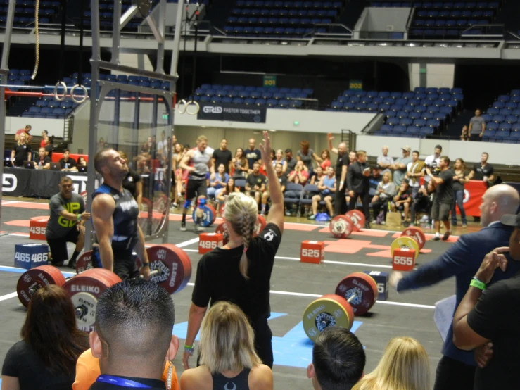 a group of people holding barbells at a competition