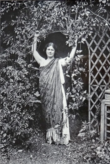a woman holding an umbrella posing with trees in the background