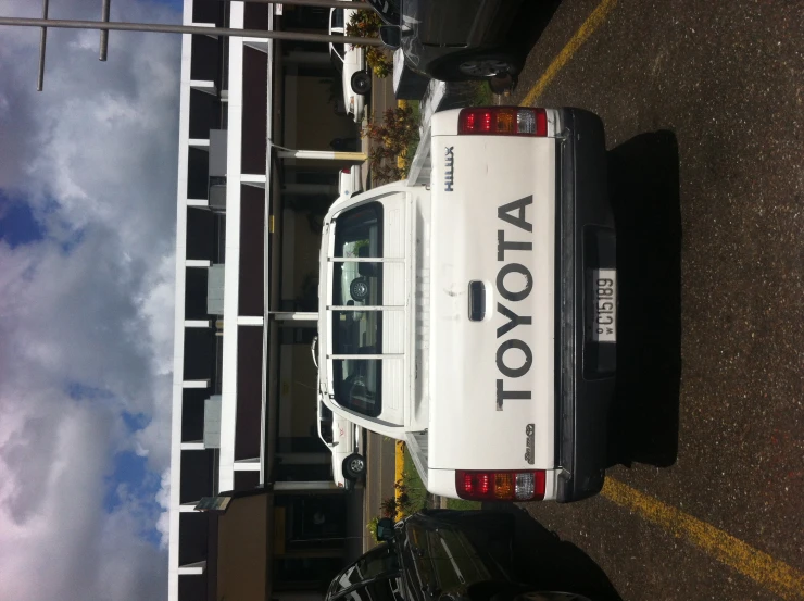 a white toyota pick up truck parked in a parking lot