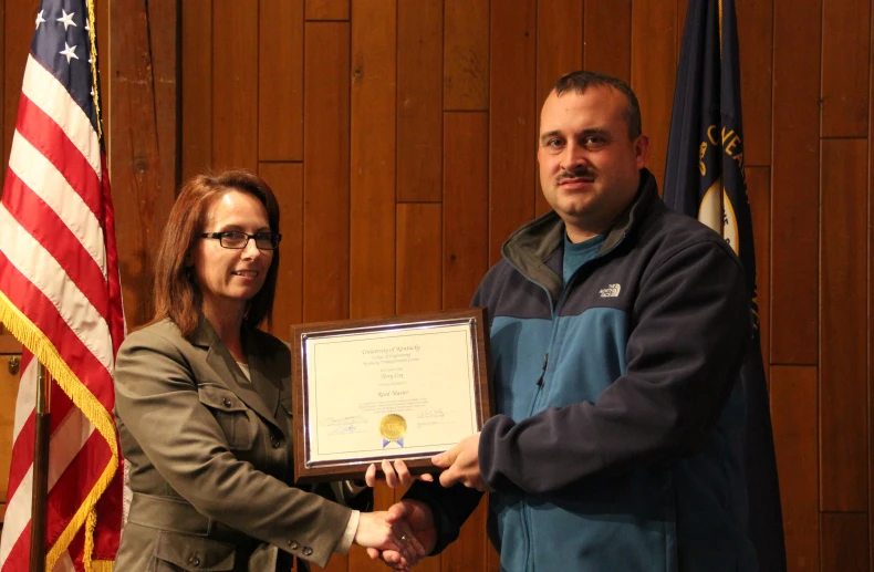 a man presenting an award to a woman