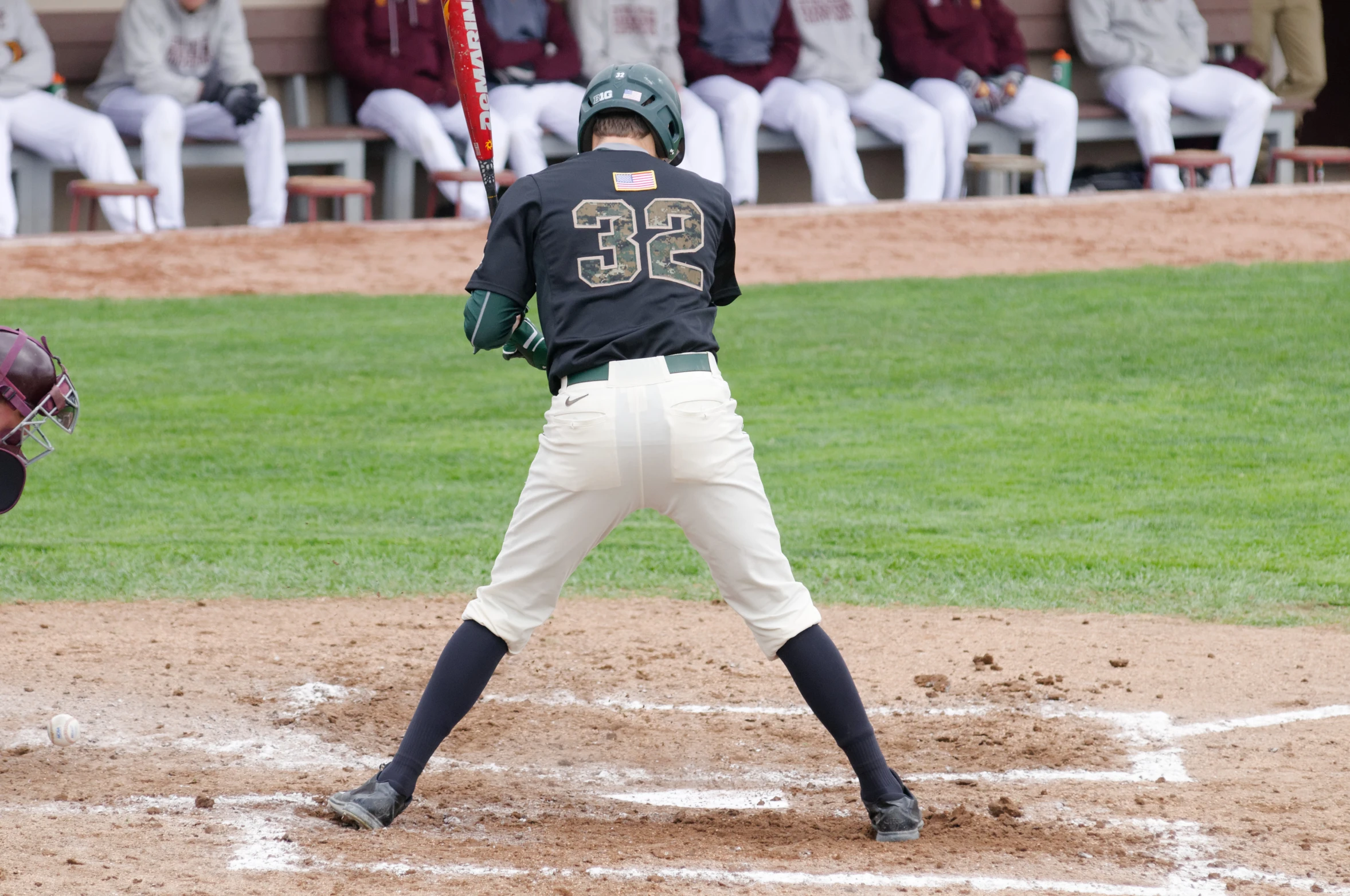 a man in a black and white uniform stands at home base