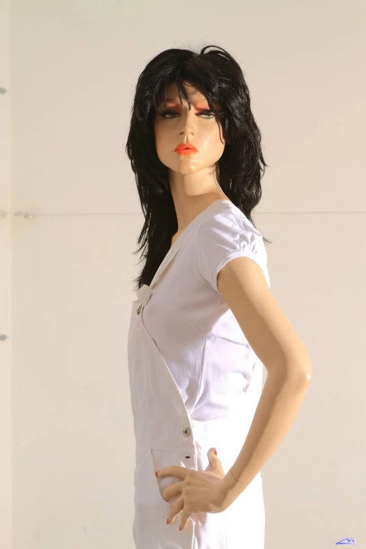 a fake female white dress is sitting on a display dummy