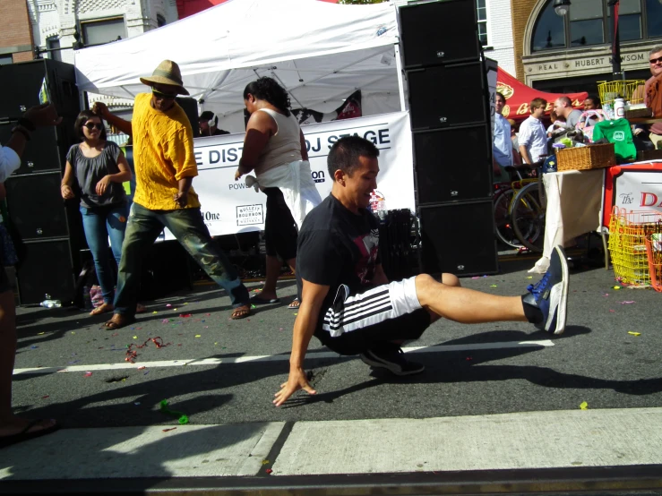 a man that is kneeling down with his foot on a street