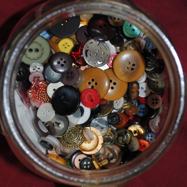 a jar full of on holes on the red fabric