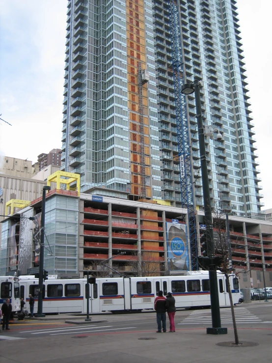 train on tracks near high rise construction area