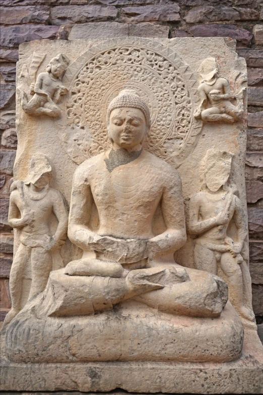 a statue of an old buddha in a meditation position