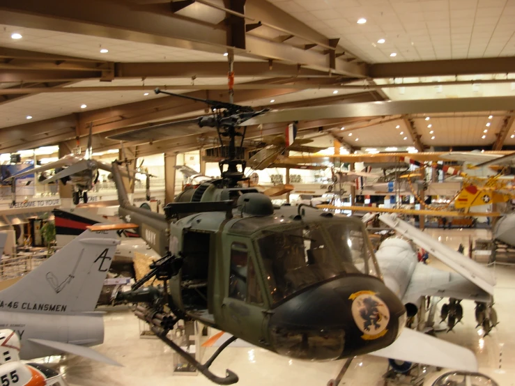 two large military helicopters are in a hanger