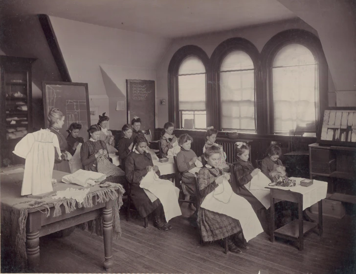 a group of children sitting in chairs at desks