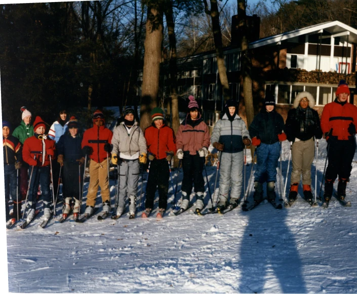 a group of people wearing skis pose for a po