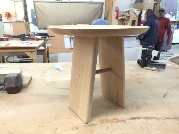 a person standing near a work bench that has a circular design