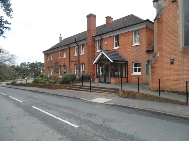 red brick building next to street in residential area