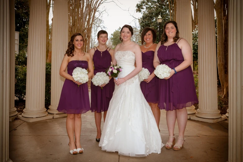 a bride and her bridally attendants posing for a pograph