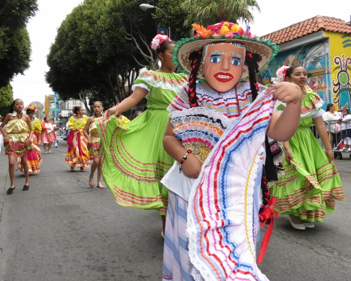 a parade of colorful people in mexican garb