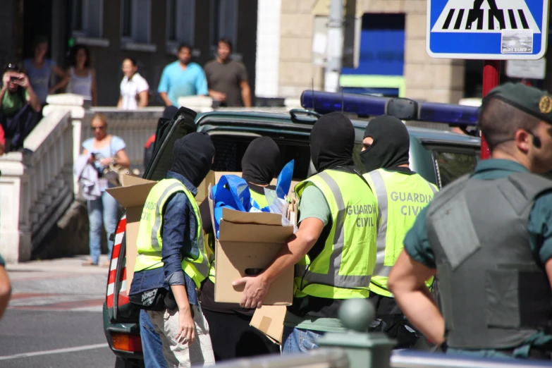 people wearing yellow vests are in the back of a truck