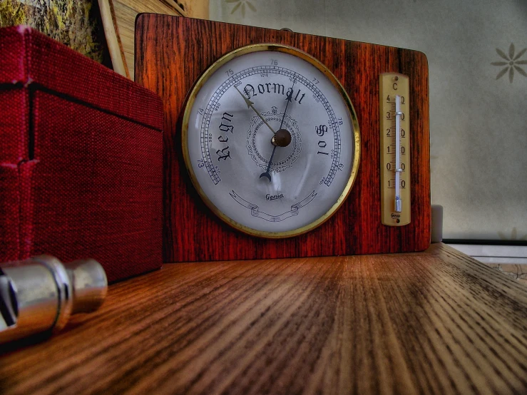 a clock sitting on top of a wooden shelf