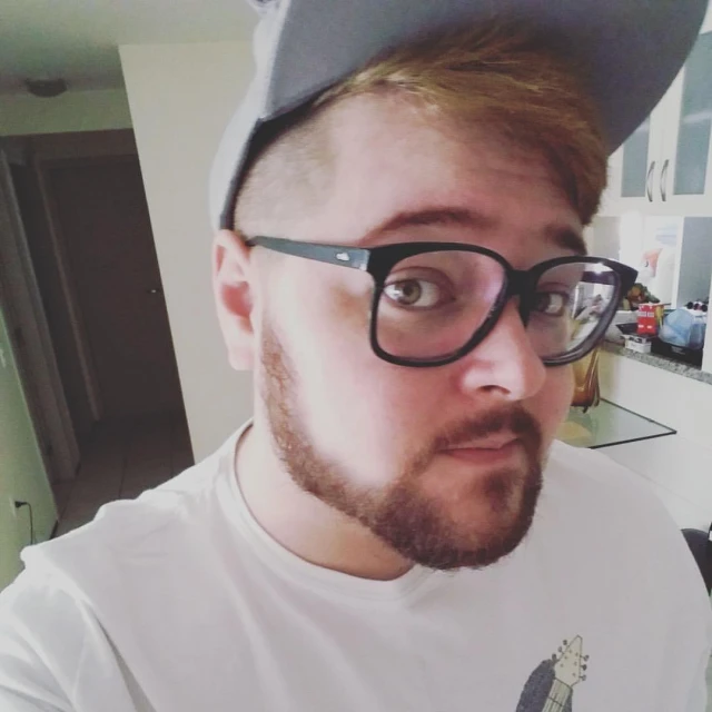 man wearing glasses and cap with beard in kitchen