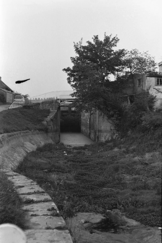 an old road near a tunnel and a house